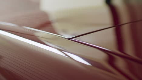 Garage-doors-opening-seen-through-car-hood-reflection