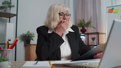 tired sleepy overworked senior business woman falling asleep sit at home office desk with laptop