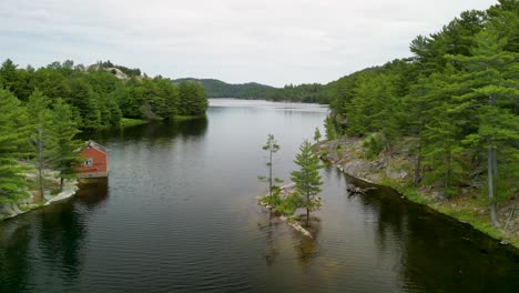 manitoulin island whitefish falls aerial view of still lake with small island and pine trees, canada drone