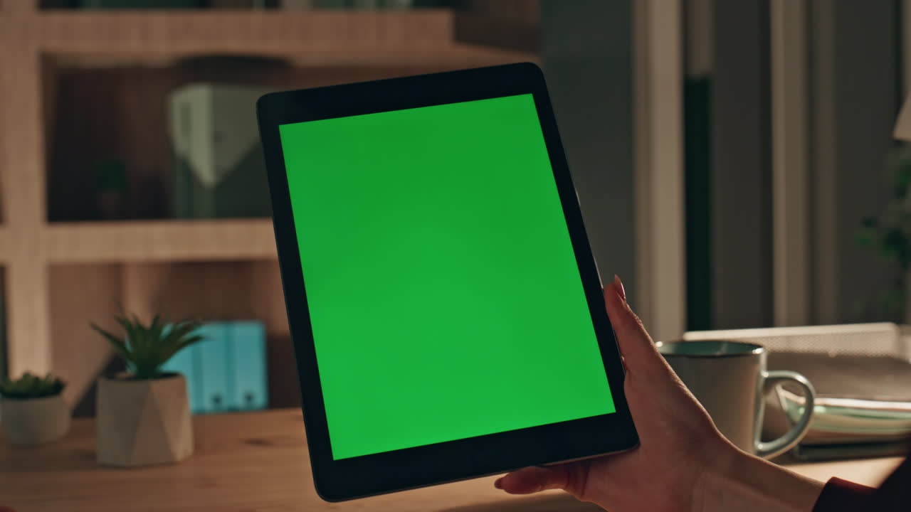 Customer zooming green screen tablet at evening home closeup. Unknown woman