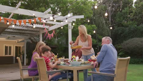 three generation family enjoying lunch outdoors