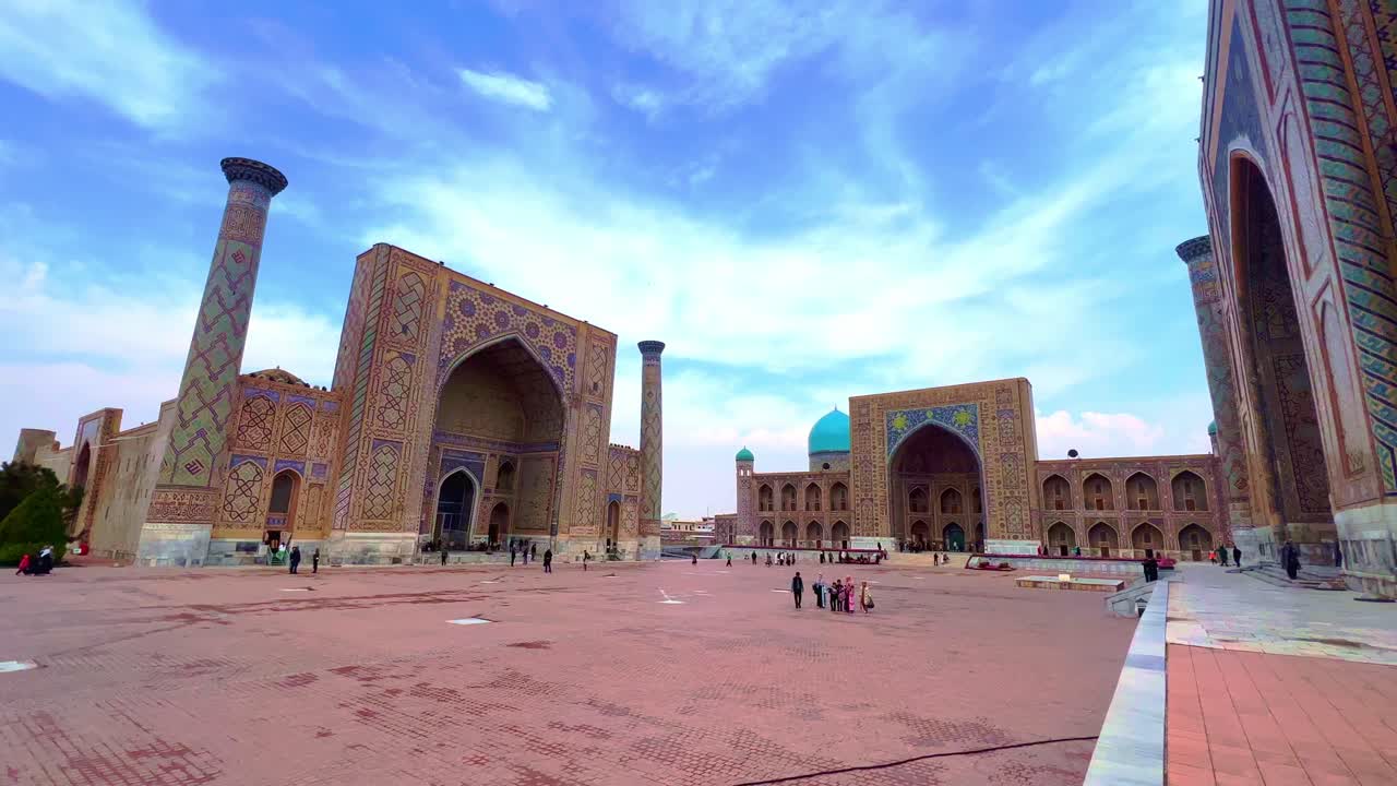 Registan Square in Samarkand, Uzbekistan, featuring historic Islamic architecture under a blue sky