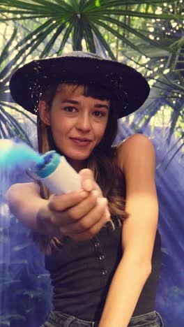 young positive caucasian woman tourist dances with smoke bomb stands in jungle