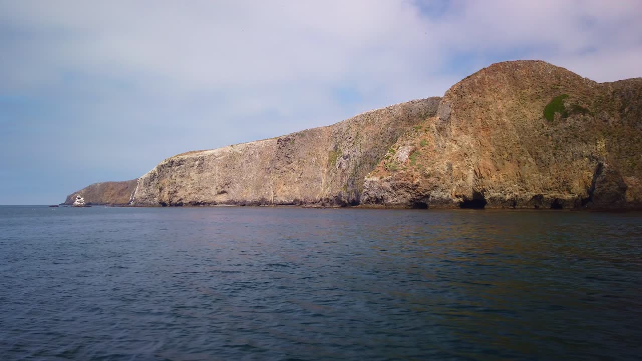Gimbal wide panning shot from a moving boat of the coastline of Middle Anacapa Island at Channel Islands National Park in the Pacific Ocean