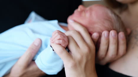 lovingly holding a newborn baby