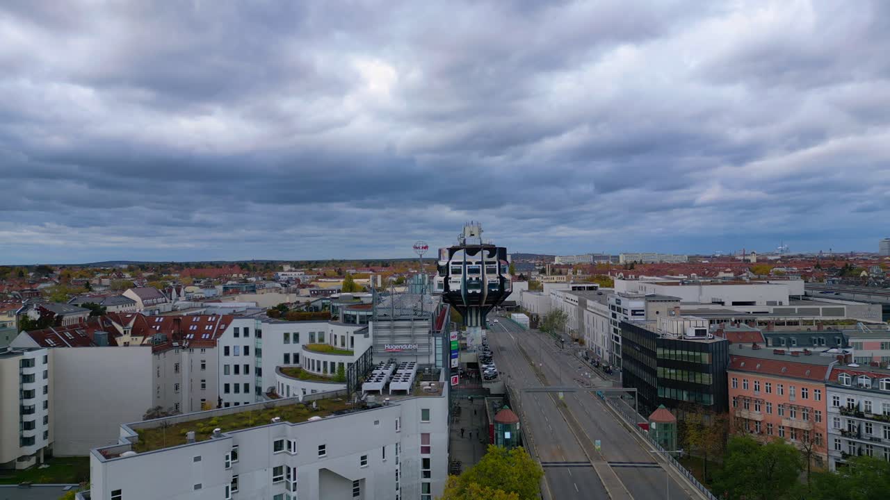 Bierpinsel Tower building standing above urban city landscape with street traffic. Dramatic aerial view flight panorama overview drone