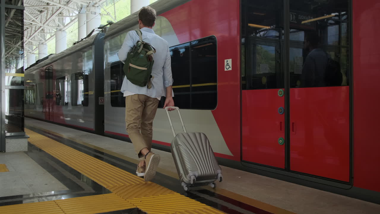 기차역 에서 가방 을 들고 있는 사람