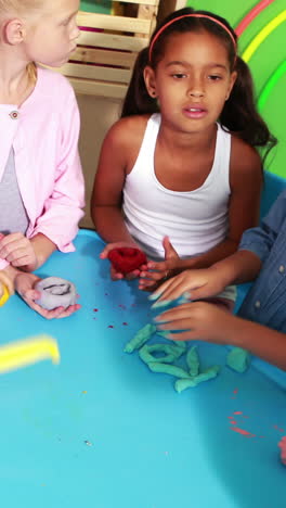 cute classmates playing with clay