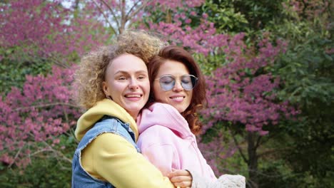 two women hugging in a spring park