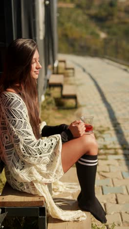 woman relaxing outdoors with tea