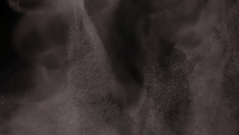 smoke, steam, fog with dust particles fly against a black background, carried away by the wind in slow motion. ice cloud of smoke, fiery smoke, rising steam, floating fog. close up