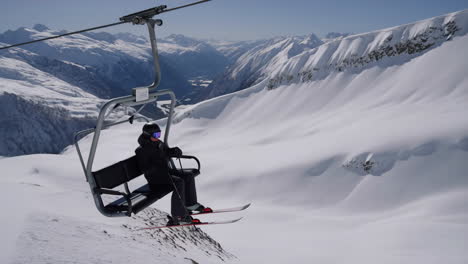 skier on a chairlift in the mountains