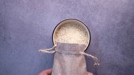 pouring rice from a bag into a bowl