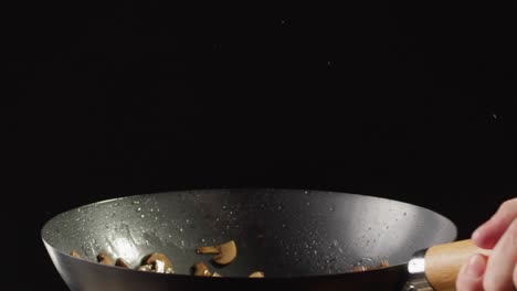cooking mushrooms in a wok