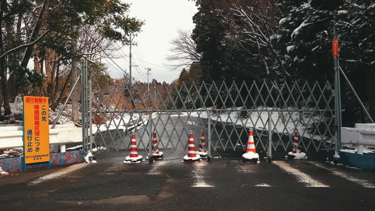 Fence and sign on the road, warning not to come into the town because of the nuclear contamination.
