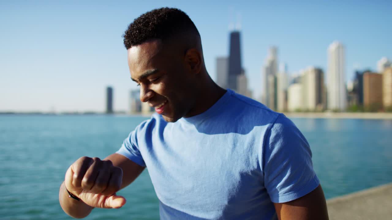 African American male stretching after workout checking pulse