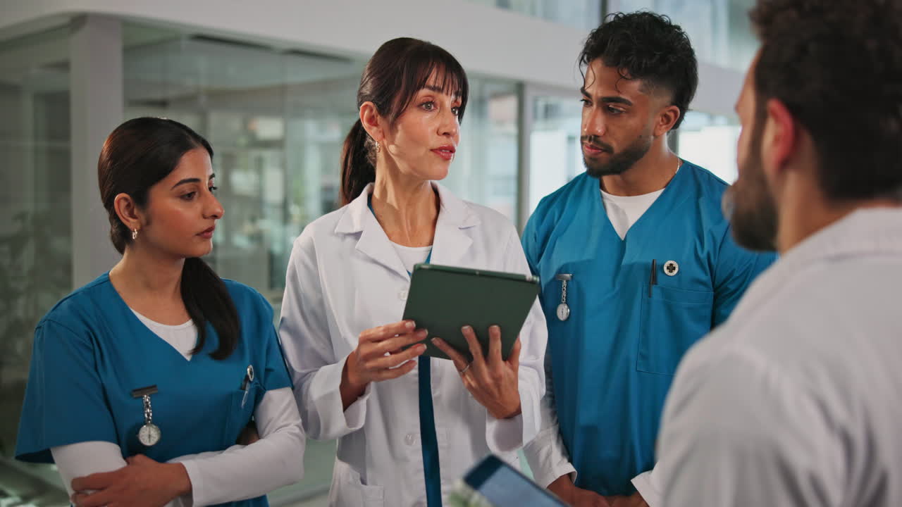 Medical Team Discussing Patient Information on a Digital Tablet