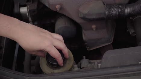 opening the cap of the power steering fluid