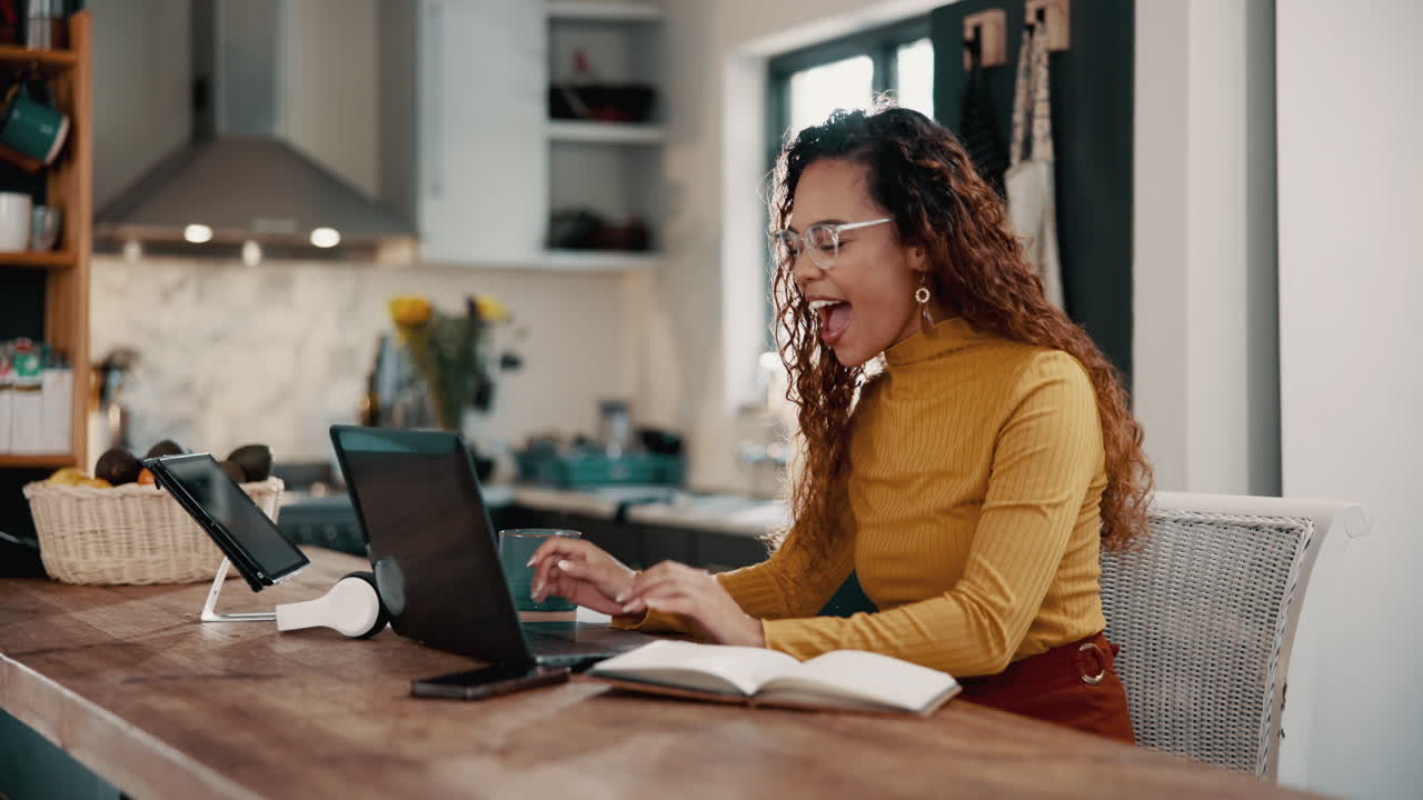 Woman celebrating success at her home office