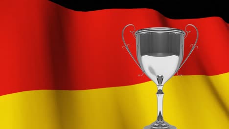 trophy in front of waving german flag