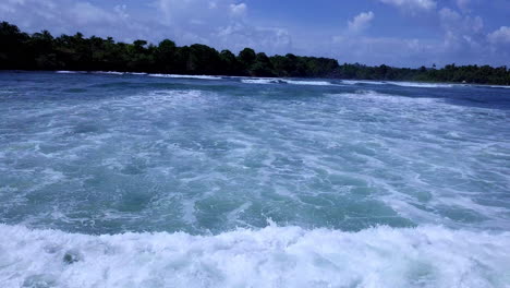 Luftaufnahme-Von-Meereswellen,-Die-An-Einem-Sonnigen-Tag-über-Das-Meer-Schwenken-Und-Landen