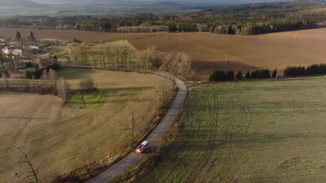 fire truck drives through rural landscape. firefighters returning from firefighting in the czech republic. drone view