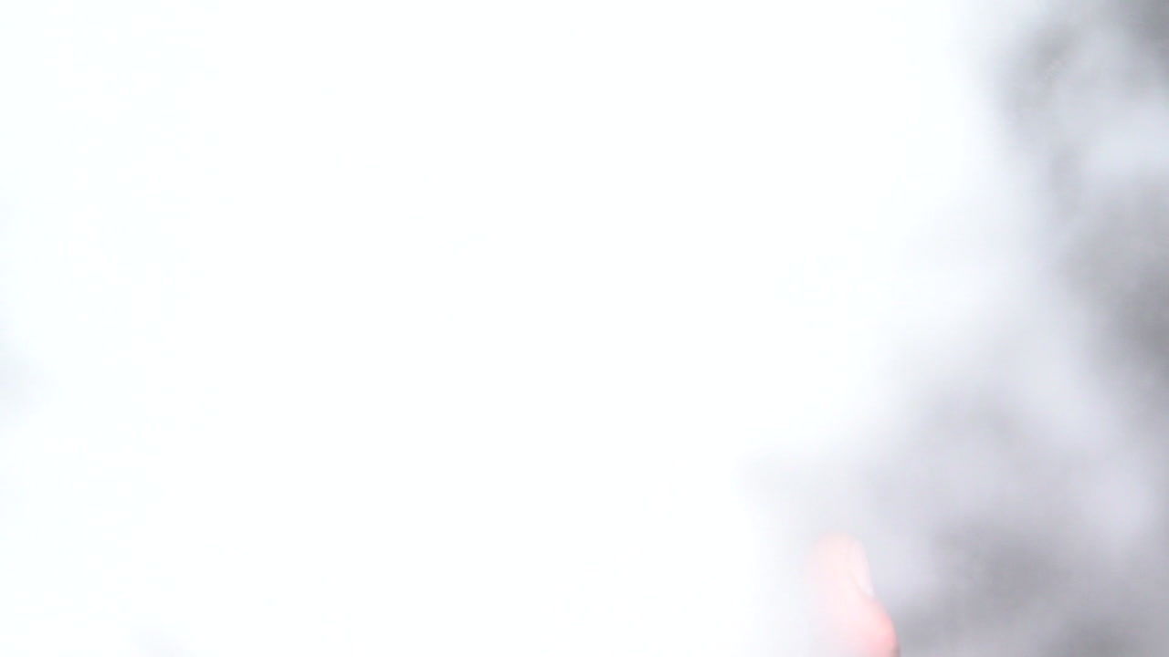 Thick White Smoke Coming From The Glass Bong Uses For Smoking Cannabis. - top-down shot