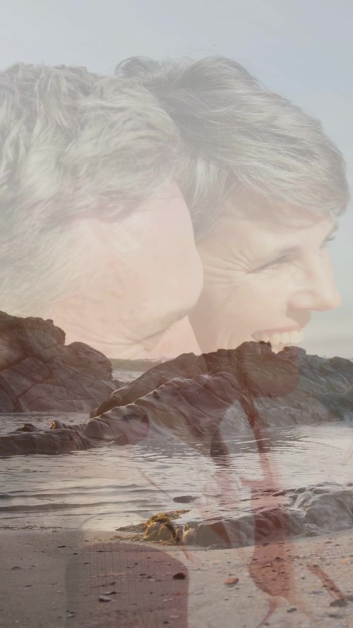 Vertical video: Mature couple leaning on rocky shore, slow fade overlay revealing smile for travel