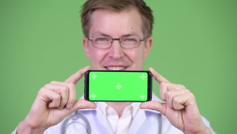 Happy Man Doctor Showing Chroma Key Green Screen Mobile Phone