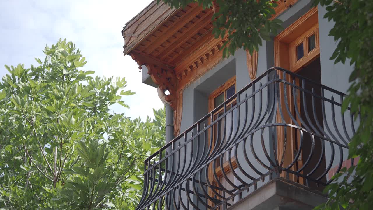 Balcony with Ornate Ironwork and Wood Details