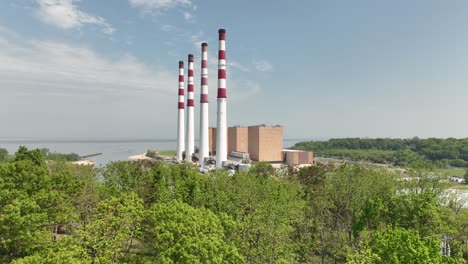 An-aerial-view-of-a-large-power-facility-on-a-sunny-day-with-blue-skies-and-white-clouds