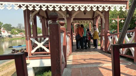 group of people walking across a picturesque bridge