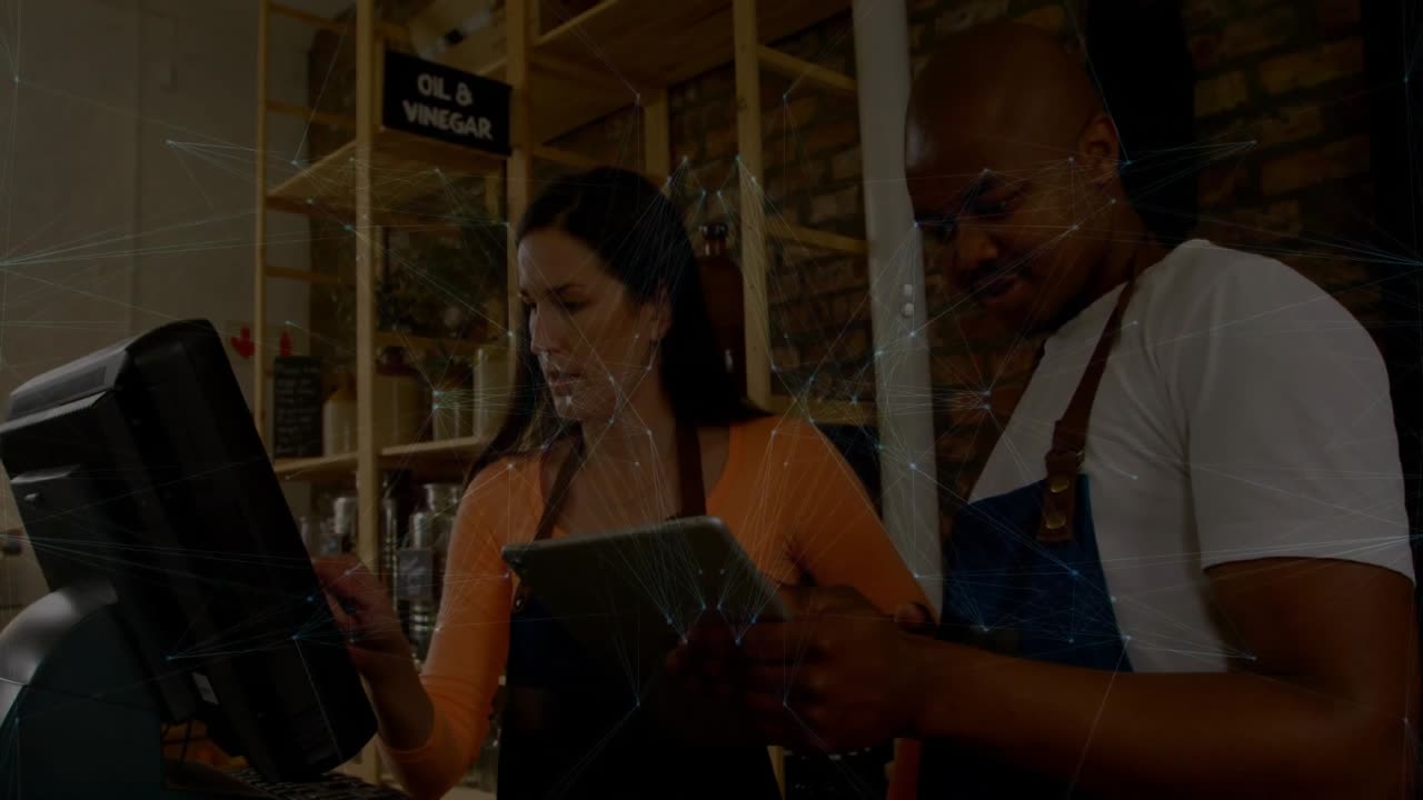 Coworkers tapping tablet and pressing register in retail store, confirming sale with globe overlay