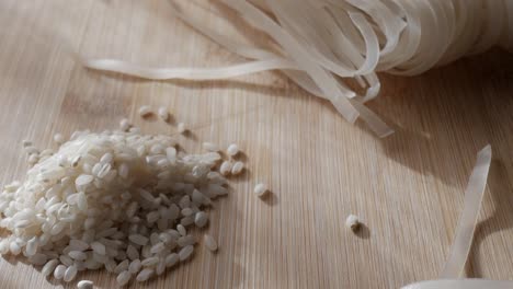 piles of rice grains and flat noodles on a bamboo surface, perfect for food preparation