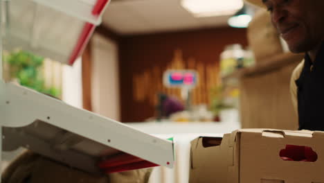 local farmer placing crates with homegrown produce on shelves