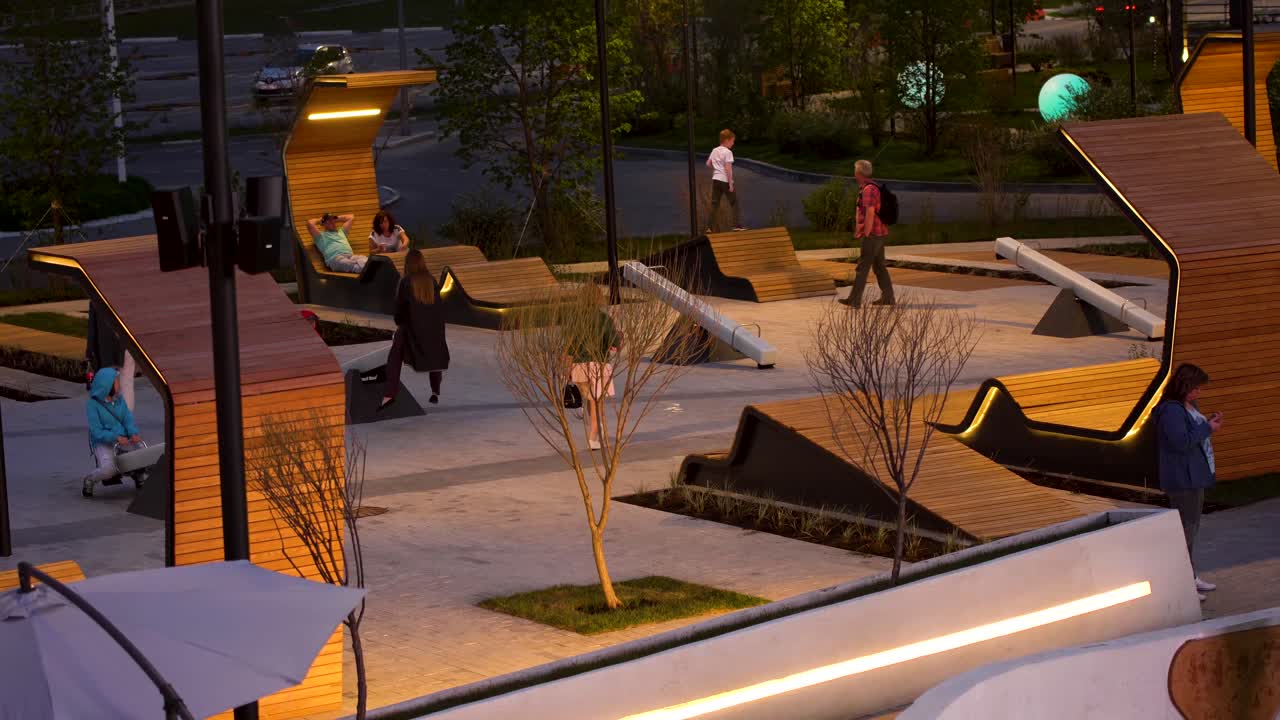 Modern Urban Park at Night with Seating and People