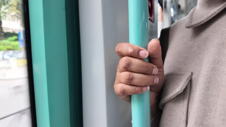 Hand holding a train pole