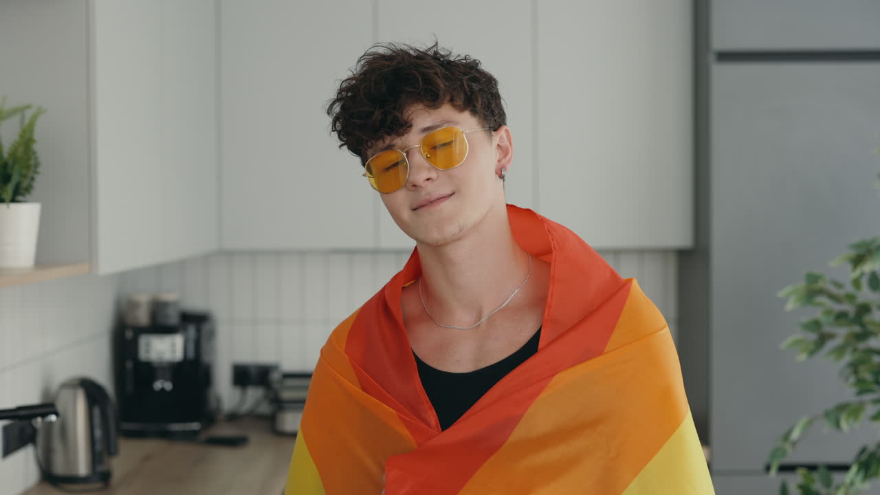 Young Man with Pride Flag in Kitchen