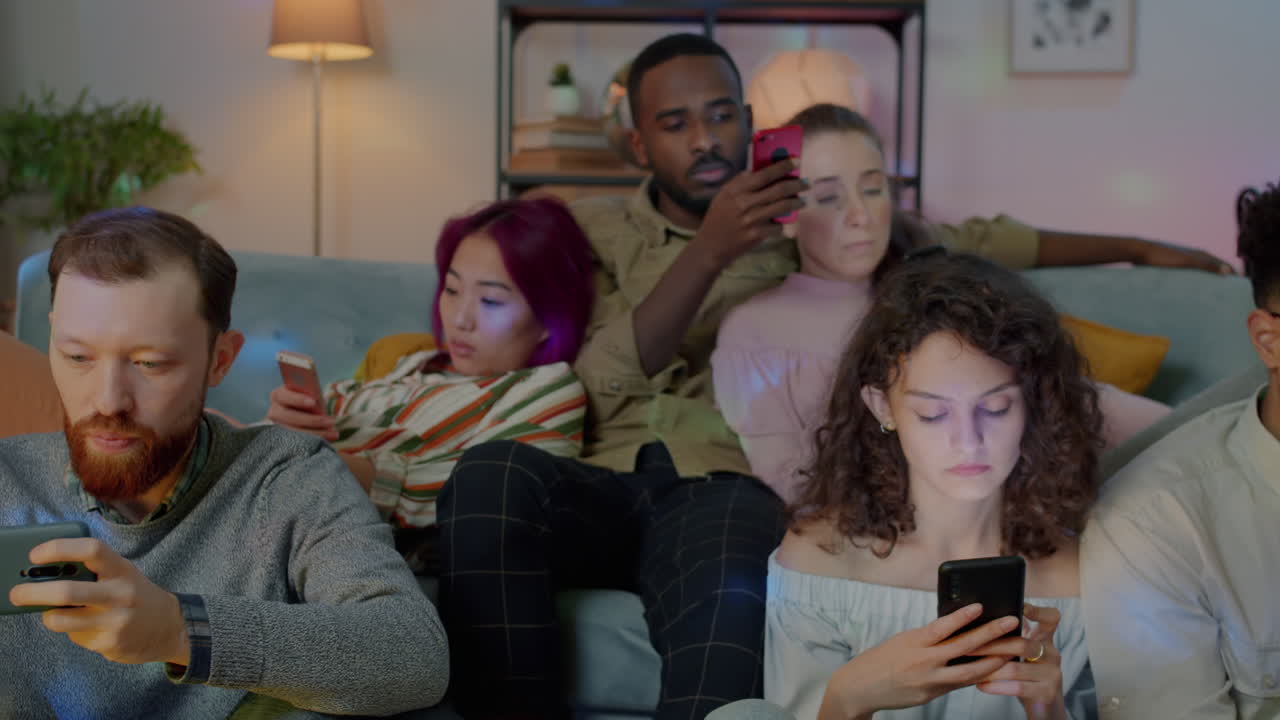 Friends using smartphones at a gathering