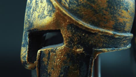 A-close-up-macro-detailed-shot-of-a-spartan-face-design,-warrior-metal-bronze-helmet,-on-a-360-rotating-stand,-studio-lighting,-4K-smooth-movement