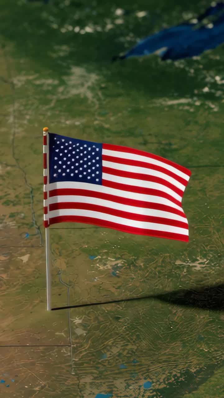 Vertical video: Starting with gentle breeze, waving American flag on flagpole over satellite map