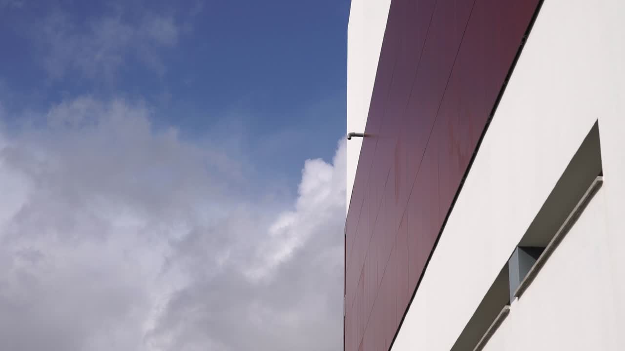 Timelapse of the clouds with building on the side.sunny day, clear