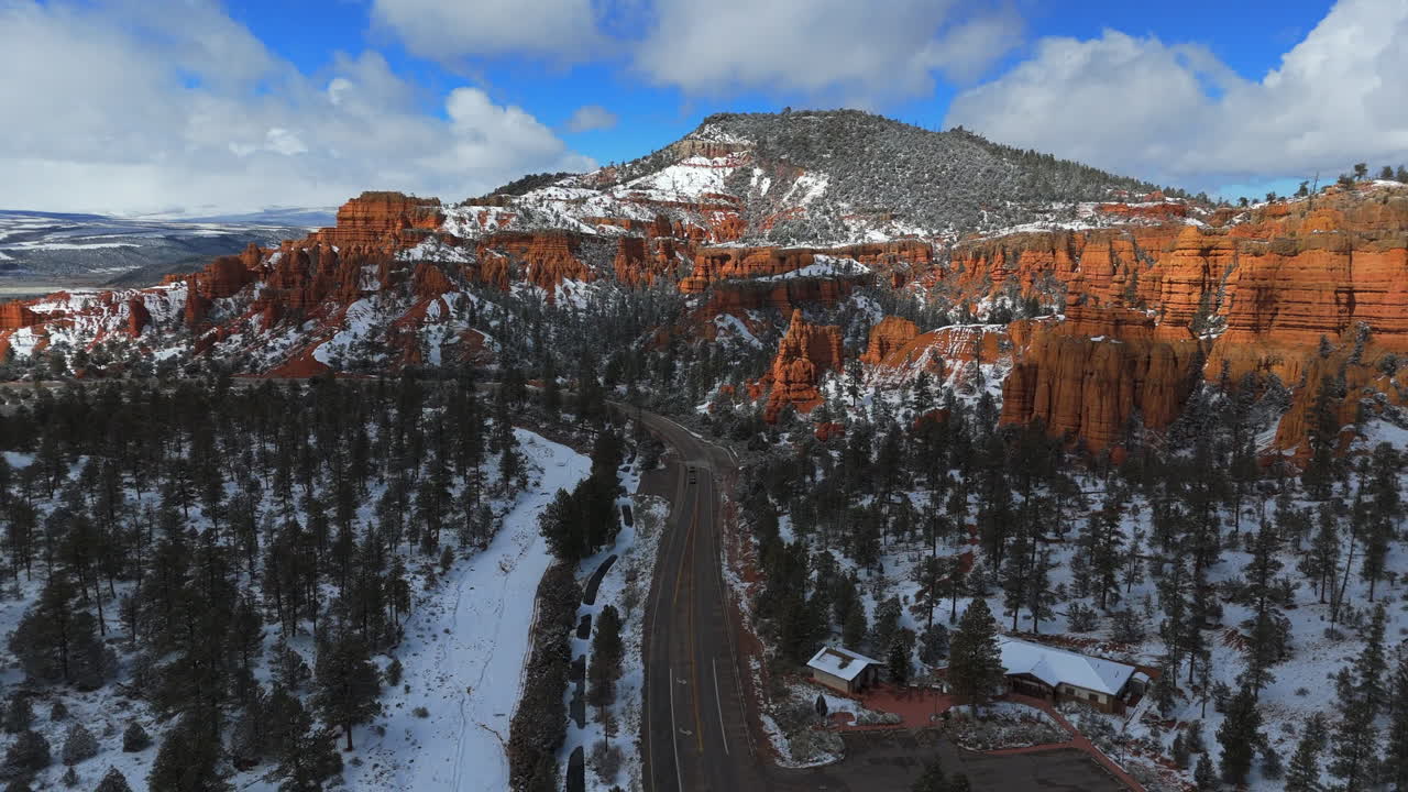 Scenic Drive Along The Snowy Bryce Canyon National Park In Utah, USA. - aerial pullback shot
