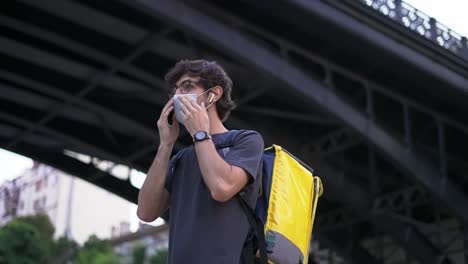 Messenger-puts-on-medical-protective-mask,-side-view