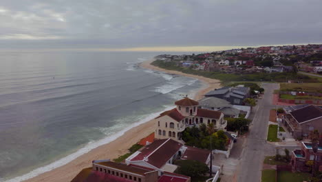 South-Africa-drone-aerial-Jeffreys-Bay-surf-town-stunning-early-morning-sunrise-golden-sun-on-ocean-surfer-wave-groundswell-Sunrise-sunset-drone-JBay-stunning-coastline-beach-cinematic-upward-motion