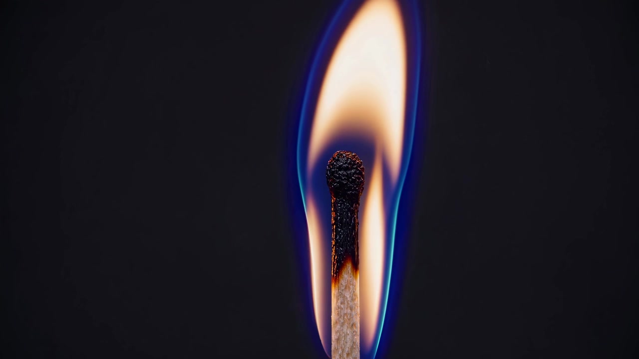 Close-up of a Matchstick Burning with a Blue Flame in Slow Motion