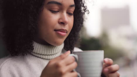 mujer disfrutando de una bebida caliente junto a la ventana