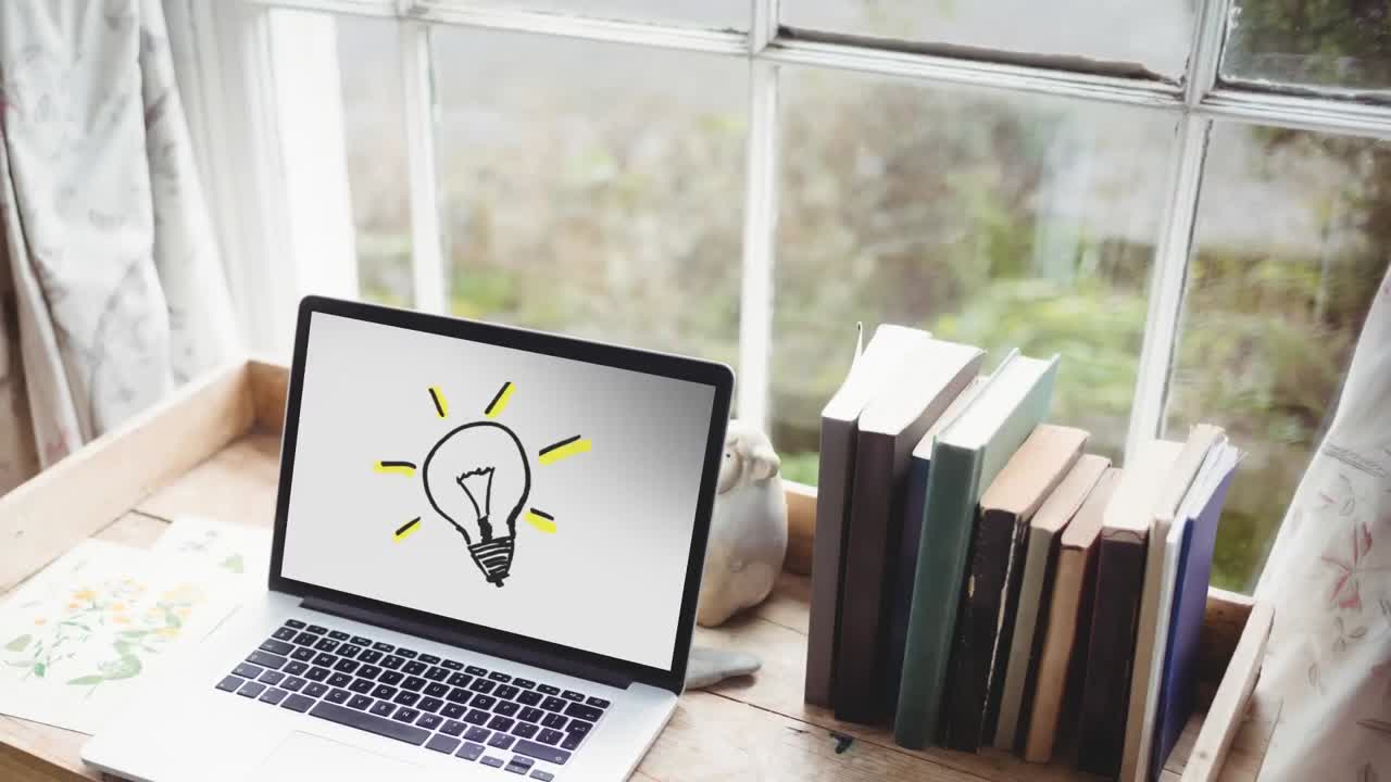 Animation of lightbulb icon on laptop screen on desk