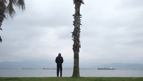 thoughtful sad man cross sea