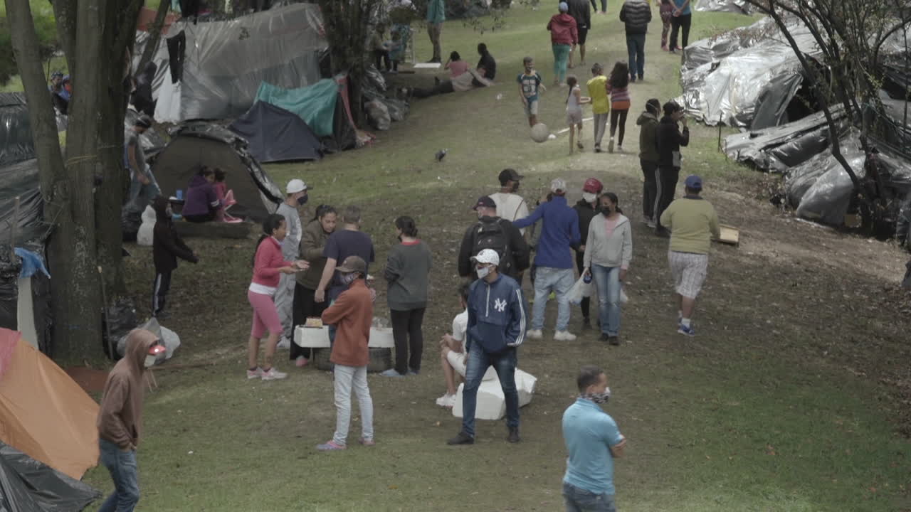 Long shot inside a Venezuelan migrant camp in Bogota - Colombia. COVID-19 crisis. After not being able to pay their rents, many try to return to their country.
